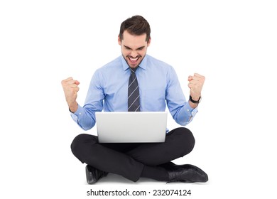 Businessman sitting with his laptop cheering on white background