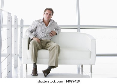 Businessman Sitting In Office Lobby