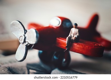 Businessman Sitting On A Red Airplane