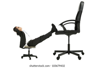 Businessman Sitting On The Small Chair Leg On The Big Chair And Thinking About Promotion