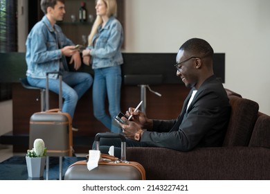 Businessman Sitting On Sofa At The Airport Lounge, Waiting For The Flight. Smiling Man Using Digital Tablet For Presentation Or New Ideas Of Business Project.