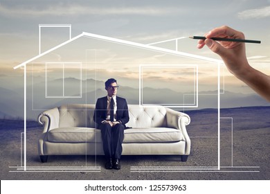 Businessman sitting white sofa in wasteland  hand drawing around him an home