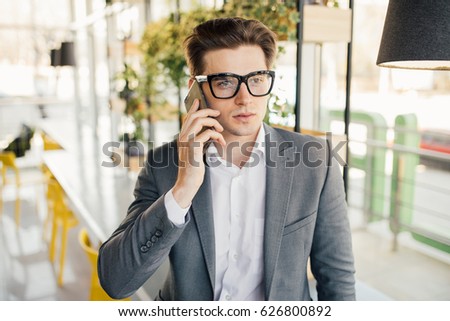 businessman sitting and using mobile phone in office