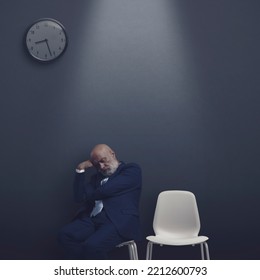 Businessman Sleeping In The Waiting Room At Night, He Has Been Waiting All Day Long For The Interview