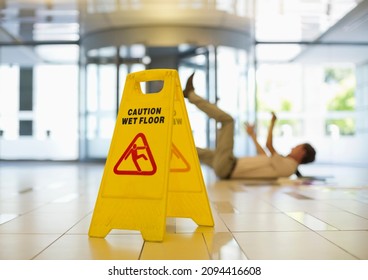 Businessman slipping on wet office floor - Powered by Shutterstock