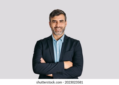 Businessman smiling with arms crossed on white background	