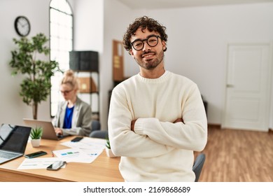 Businessman smiling happy with arms crossed gesture standing at the office. - Powered by Shutterstock