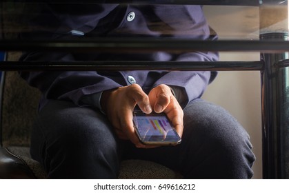 Businessman Sneak Look A Phone In The Meeting Room. Under The Table.