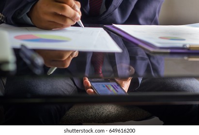 Businessman Sneak Looking A Phone In Office. Under The Table.