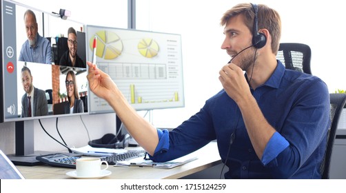 Businessman speak talk on video call with colleagues on online briefing during self isolation and quarantine. Webcam group conference with coworkers on laptop at office. Flu epidemic and covid-19. - Shutterstock ID 1715124259