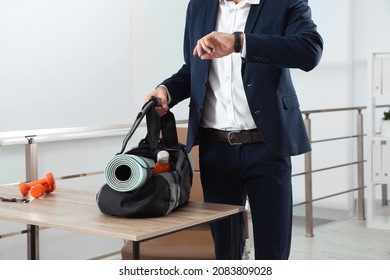 Businessman With Sports Bag In Office, Closeup