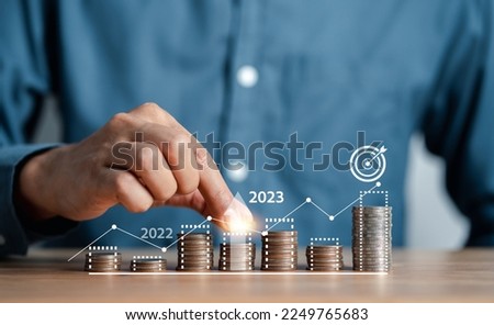 Businessman stacking money coins accounting for increase financial interest rate and business investment growth from dividend, Business Finance and Money, Save money for prepare in the future.