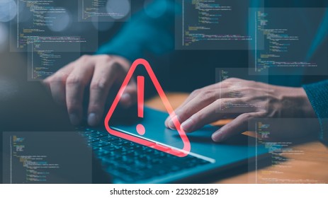 Businessman or it staff , programmer, developer using computer laptop with triangle caution warning sign for notification error and maintenance concept.	