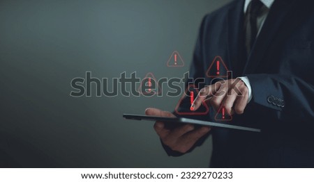 Businessman staff, programmer, developer using technology with triangle caution warning sign notification error and maintenance concept. System warning hacked alert, cyberattack on computer network.