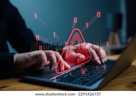 Businessman or it staffs, programmer, developer using computer laptop with triangle caution warning sign for notification error and maintenance concept, System warning hacked alert, cyberattack.