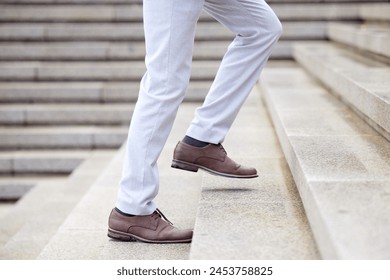 Businessman, stairs and success taking steps toward progress, development and achievement for industry. Entrepreneur, walking and climbing up the corporate ladder, financial and career growth for job