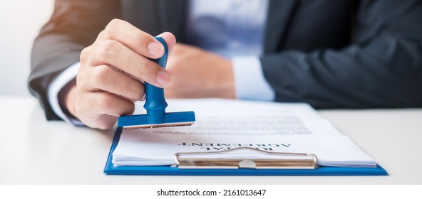 Businessman stamp during signing contract document.Business contract, approve, partnership, contract agreement and quality assurance concepts