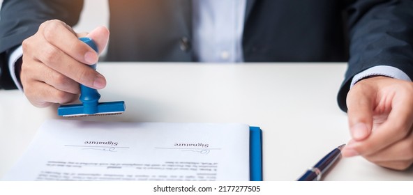 Businessman stamp during signing contract document.Business contract, approve, partnership, contract agreement and quality assurance concepts