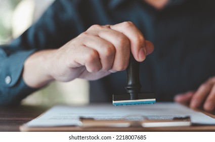 Businessman Stamping With Approved Stamp On Document At Desk.Approval Concept Business Assurance, Law, Contract, Insurance, And Warranty.