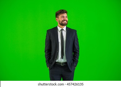 The businessman stand on the green background - Powered by Shutterstock