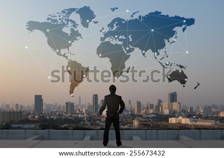 businessman stand on roof top of skyscraper, business globalization concept