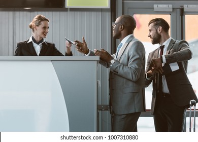 businessman standing at airport check in counter, hurry up on plane concept - Powered by Shutterstock