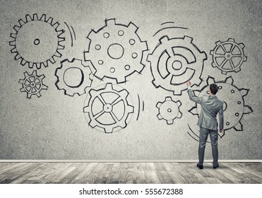 Businessman standing with back and drawing concept of teamwork and cooperation