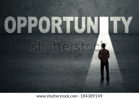 Businessman standing in front of opportunity door