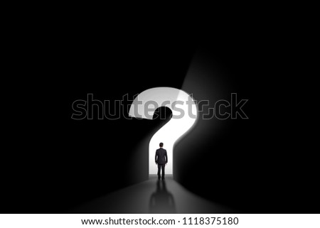 businessman standing in front of a portal shaped as a questionmark