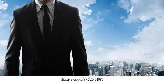 Businessman standing and looking at the city