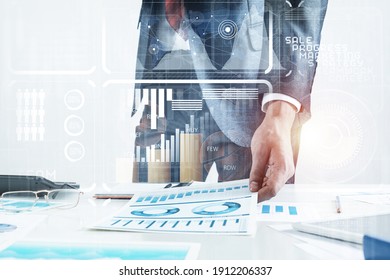 Businessman Standing Near Office Desk And Analyzing Financial Charts. Successful Corporate Manager In Business Suit And Tie. Close-up Man Hand With Analytics. Entrepreneurship And Leadership Concept.