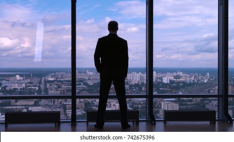 Businessman Standing Near The Window And Looking Into It. Man Stands Near The Stained Glass