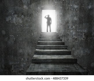 Businessman standing old top of concrete stairs with open door and bright light. - Shutterstock ID 488437339