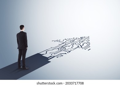 Businessman standing on abstract circuit arrow sketch on white background with mock up place. Success and digital transformation concept