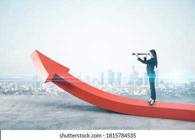 Businessman standing on abstract red arrow and using telescope on city background. Finance and vision concept