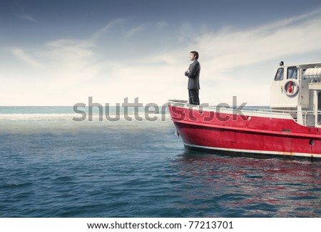 Businessman standing on a boat