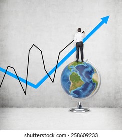 businessman standing on globe and drawing chart. Elements of this image furnished by NASA.