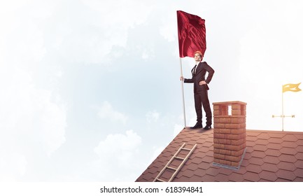 Businessman standing on house roof and holding red flag. Mixed media - Shutterstock ID 618394841