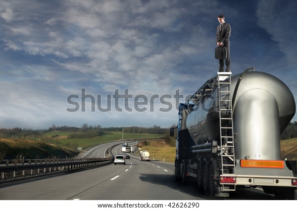 businessman standing on oil\
track