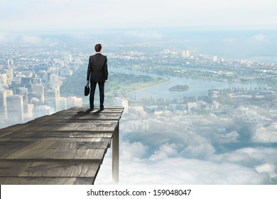 businessman standing on pier an looking on city - Powered by Shutterstock