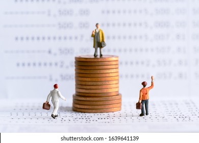 Businessman Standing On A Pile Of Coins. Income Inequality Gap Concept.