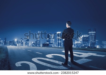 Businessman standing on the road and looking ahead in 2024