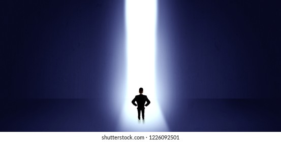 Businessman standing and seeing the light at the end of a big wall - Shutterstock ID 1226092501