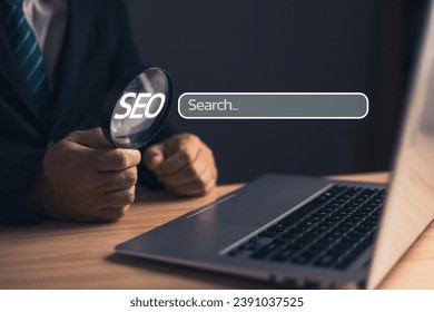 Businessman standing in suit holding magnifying glass.Searching Browsing Internet Data Information with blank search bar. Search Engine Optimization SEO Networking Concept.