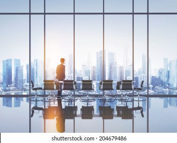 Businessman Standing In Sunny Office