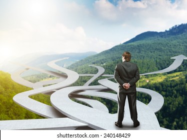 Businessman stands choosing his way - Shutterstock ID 240148429