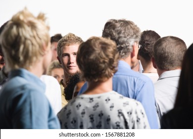 Businessman Staring Out From Crowd Of Co-workers