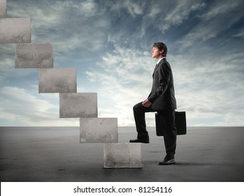 Businessman Stepping Up A Staircase