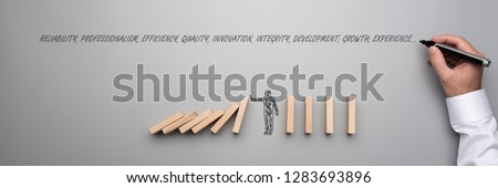 Businessman stopping falling dominos over grey background and male hand writing words reliability, professionalism, efficiency, qua