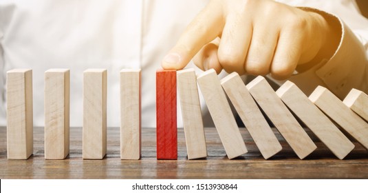 Businessman stops domino falling. Risk management concept. Successful strong business and problem solving. Reliable leader. Stop the destructive processes. Strategy development. Debt restructuring